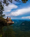 Dragon Crest mountain Krabi Thailand, a Young traveler sits on a rock that overhangs the abyss, with a beautiful Royalty Free Stock Photo