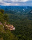 Dragon Crest mountain Krabi Thailand, a Young traveler sits on a rock that overhangs the abyss, with a beautiful Royalty Free Stock Photo