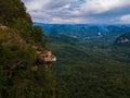 Dragon Crest mountain Krabi Thailand, a Young traveler sits on a rock that overhangs the abyss, with a beautiful Royalty Free Stock Photo