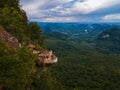 Dragon Crest mountain Krabi Thailand, a Young traveler sits on a rock that overhangs the abyss, with a beautiful Royalty Free Stock Photo