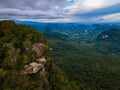 Dragon Crest mountain Krabi Thailand, a Young traveler sits on a rock that overhangs the abyss, with a beautiful Royalty Free Stock Photo