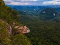 Dragon Crest mountain Krabi Thailand, a Young traveler sits on a rock that overhangs the abyss, with a beautiful