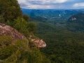 Dragon Crest mountain Krabi Thailand, a Young traveler sits on a rock that overhangs the abyss, with a beautiful Royalty Free Stock Photo