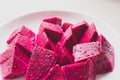 Ripe dragon fruit isolated on white background. Sweet pitaya on a plate, space for text