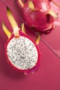 Dragon fruit half on birght pink background