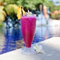 Dragon fruit juice. Hotel rest. Dragon fruit shake. Fresh cocktail and frangipani flowers by the pool. Royalty Free Stock Photo