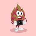 Dragon fruit mascot and background with camera pose Royalty Free Stock Photo