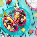 Dragon fruit salad bowls on a bright turquoise plate and background. Royalty Free Stock Photo