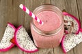 Dragon fruit smoothie in jar mug on wood background