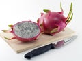 dragon fruit on square wooden cutting board and kitchen knife Royalty Free Stock Photo