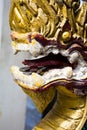 Dragon Laos Buddhist ancient sculpture. Golden dragon head closeup in Thailand in the temple