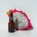 Dragon pitaya fruit extract for skin care, dark glass dropper bottles with essential oil. A recipe for a homemade nourishing