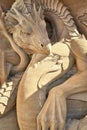 Dragon protects mermaid as a sculpture in the sand