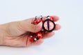 Dragon red eye cabochon and ceramic beads in a girl s hand on a white background. Amulet