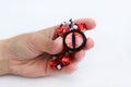 Dragon red eye cabochon and ceramic beads in a girl s hand on a white background. Amulet