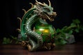 Dragon-shaped lantern in emerald hue on the table. Black background, side view Royalty Free Stock Photo