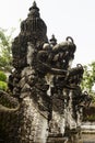 Dragon statues carved of stone decorate of traditional balinese sacred temple of Lempuyang on Bali, vertical, fragment. Majestic. Royalty Free Stock Photo