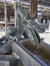 A dragon supplying water at purification fountain. Royalty Free Stock Photo