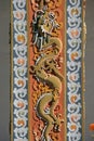 A dragon was sculptured on a pillar in the courtyard of a buddhist temple in Thimphu (Bhutan) Royalty Free Stock Photo