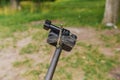 Dragonfly sits on tripod action camera in nature. Shooting nature action camera. Interesting insects