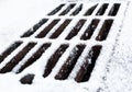 Drain grate covered with snow Royalty Free Stock Photo