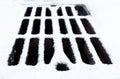 Drain grate covered with snow Royalty Free Stock Photo