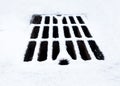 Drain grate covered with snow Royalty Free Stock Photo