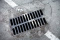 Drain grate with road marking line on it Royalty Free Stock Photo