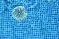 Drain hole in the pool with blue tile. Pool filtration system. Clean water