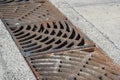 Drain of metal grate around with rough beton road Royalty Free Stock Photo