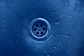 Drain in a metal sink. Drops of water on a metal surface Royalty Free Stock Photo