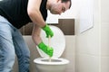 Drain Problems, blockage plumbing toilet unclog plunger force cup man sit floor Royalty Free Stock Photo