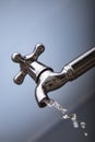 Drain water from the Metal tap, Water flowing from modern faucet Royalty Free Stock Photo