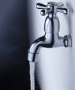 Drain water from the Metal tap, Water flowing from modern faucet Royalty Free Stock Photo