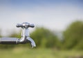 Drain water from the Metal tap outdoors Royalty Free Stock Photo