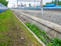 the drainage canal at the railway station overgrown with grass was partially cleared