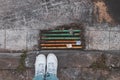 Valencia, Spain; May 12 2020: Drainage colorful sewer in the city and white sneakers