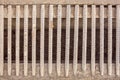 Drainage channel with a grate made of iron rods . Royalty Free Stock Photo