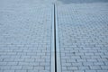 Drainage element in interlocking paving concrete gutter with slotted drain from one piece of concrete Royalty Free Stock Photo