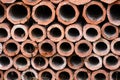 Drainage old clay pipes for sewage stacked in a texture with holes Royalty Free Stock Photo