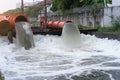 Drainage pipe with water flowing into the river Royalty Free Stock Photo