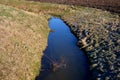 Drainage drainage reclamation channel is an outdated way to lower groundwater levels. dikes of gray stones. supplies water to irri Royalty Free Stock Photo