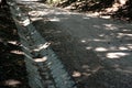 Drainage of the threshing floor in the forest beige color transverse metal gutters drain the water into the ditch paved riverbed