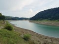 Drained lake bed with little water in the bed Royalty Free Stock Photo