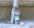 Drainpipe broken by ice on the wall of the house