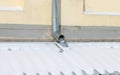 Drainpipe on the wall, frozen icicle
