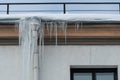 The drainpipes are covered with ice and snow. After a heavy snowstorm, the city is covered with snow and ice. There are many