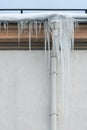 The drainpipes are covered with ice and snow. After a heavy snowstorm, the city is covered with snow and ice. There are many