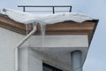 The drainpipes are covered with ice and snow. After a heavy snowstorm, the city is covered with snow and ice. There are many