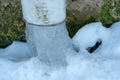 The drainpipes are covered with ice and snow. After a heavy snowstorm, the city is covered with snow and ice. There are many